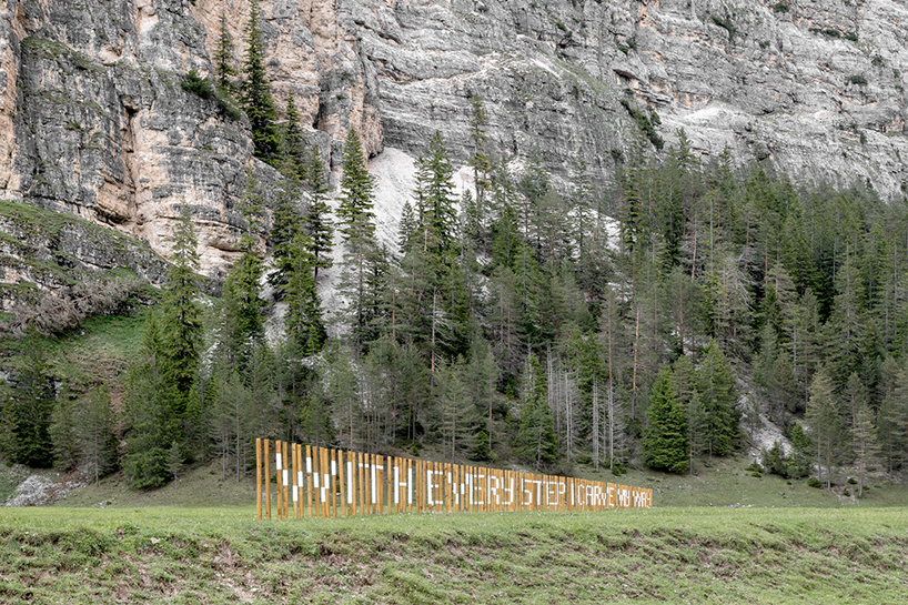 hundreds of wooden poles make up anamorphic installation spreading across italian hillside post thumbnail image